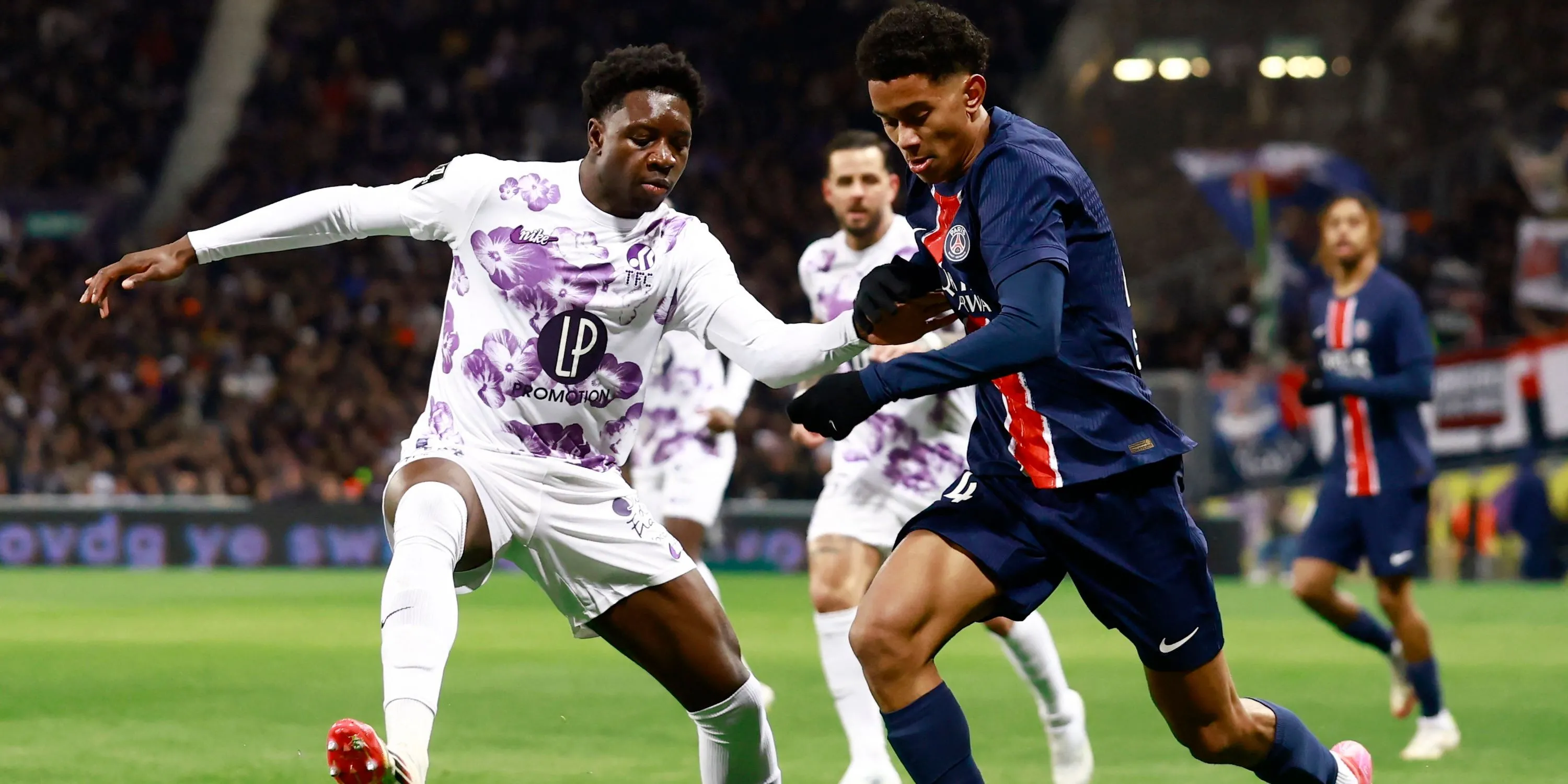 Hậu vệ trẻ Jaydee Canvot của Toulouse tranh chấp bóng với Senny Mayulu của Paris Saint-Germain
